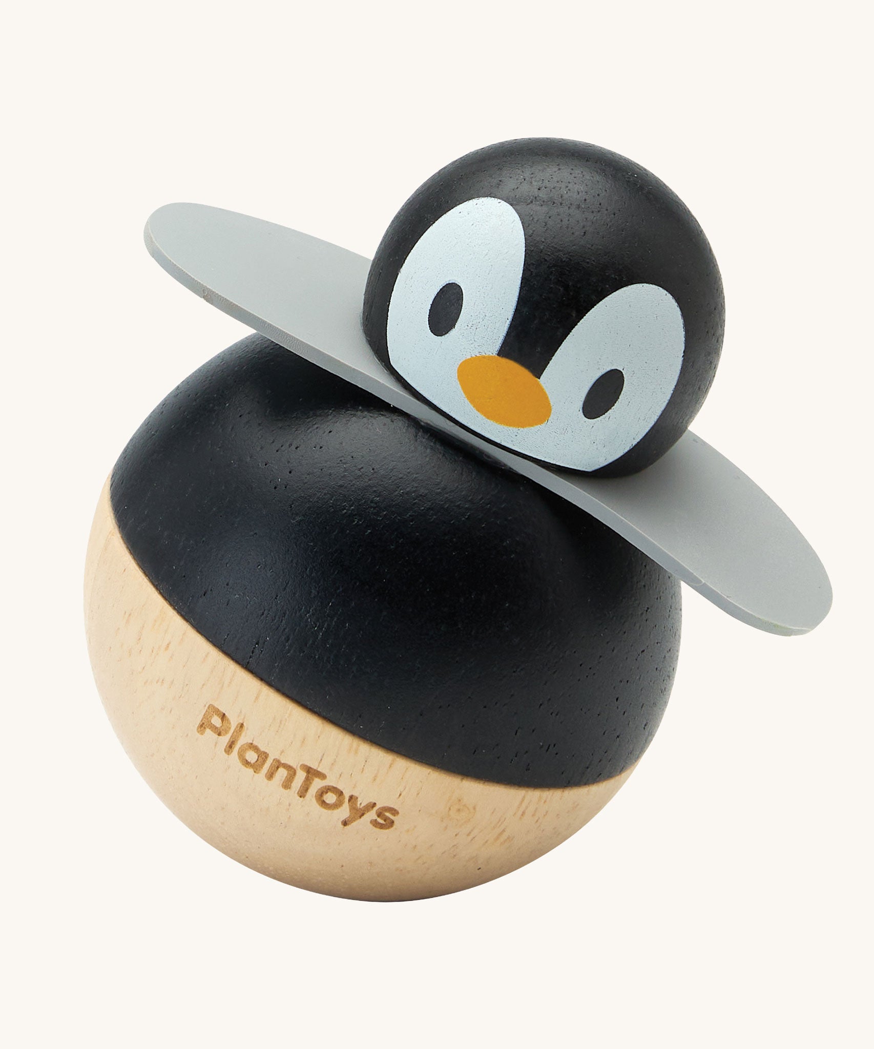 PlanToys Penguin Wobbler wooden baby toy. A circular shaped penguin toy that wobbles when placed on a flat surface. PlanToys range of toys are made from sustainably sourced rubberwood, we're proud stockists of PlanToys here at Babipur. 