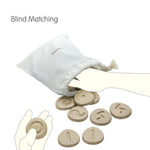 overflowing with the Plan Toys plastic free tactile stone circles on a white background