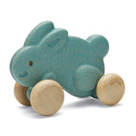 Plan Toys eco-friendly wooden push along bunny toy in blue on a white background