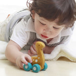 Child playing with the PlanToys Dino Car - Diplo