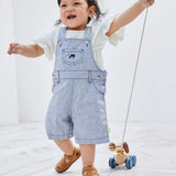 Child pulling the PlanToys push and pull puppy wooden toy by the string attachement.