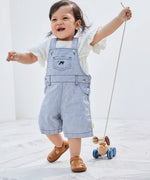Child pulling the PlanToys push and pull puppy wooden toy by the string attachement.