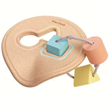 The PlanToys Shape Sorter in pastel shades on a plain background. 