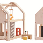 The PlanToys Slide N Go Dolls' House shown with the pieces separated on a plain background. 