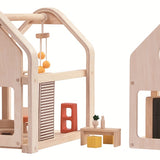 The PlanToys Slide N Go Dolls' House shown with the pieces separated on a plain background. 