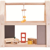 The PlanToys Slide N Go Dolls' House shown extended from the side with furniture inside on a plain background. 