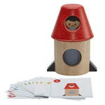 The PlanToys Spatial Rocket on a plain background. The cards that feature different ways to set up can be seen in front of the rocket. 

