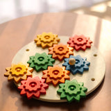 PlanToys spinning gear wooden toy playset placed on a circular table.