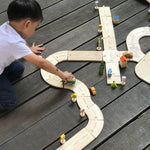 Child playing with the Plan Toys Standard Road System