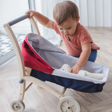 PlanToys stroller with a teddy bear lying inside