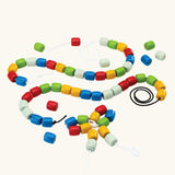 PlanToys threading beads wooden lacing toy. Rainbow coloured wooden beads threaded onto black and white laces.