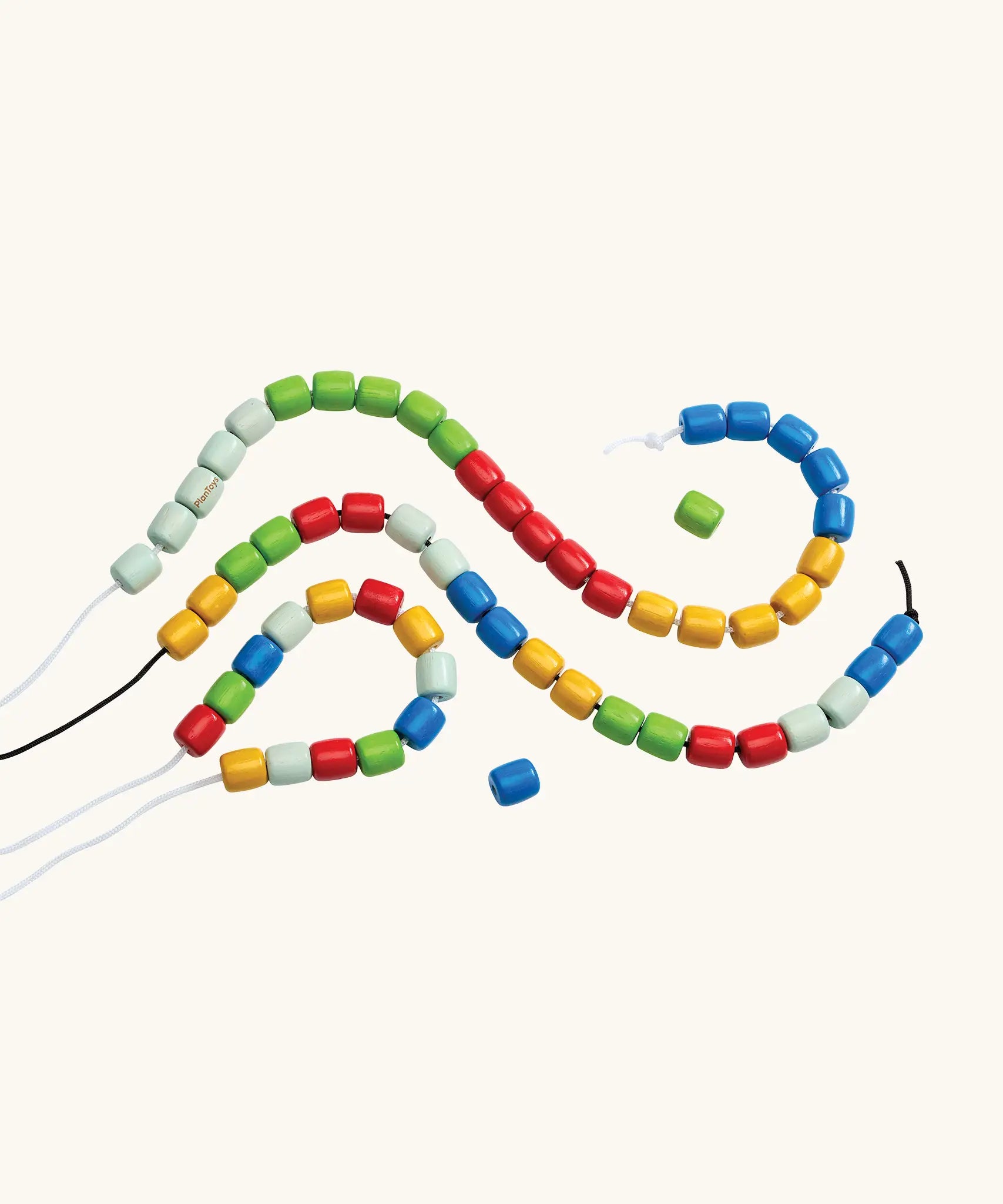PlanToys threading beads wooden lacing toy. Rainbow coloured wooden beads threaded onto black and white laces.