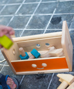 PlanToys wooden robot toolbox play set on the floor with screws inside