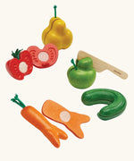 Set of 5 PlanToys wonky fruit and veg pieces with velcro tabs on the inside to pull. Includes a wooden knife