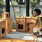 Child playing with different PlanToys wooden play kitchen units