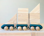 PlanToys blue wooden hybrid train placed on natural wooden blocks. Three carriage train with magnetic connections. 