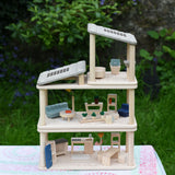 The living room, kitchen / diner and bathroom Plan Toys PlanSpace sets shown stacked on top of each other to create a 3 storey house. The levels can be arranged to the users preference offering a fully customised set up. 