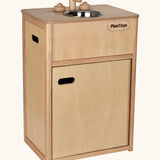 PlanToys wooden play sink. Features a bottom compartment, carry handles, tap knobs and a metal bowl