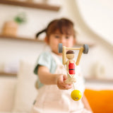 Child playing with the PlanToys Weightlifting Acrobat wooden toy.