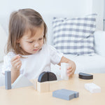 A child playing with the Plan Toys Fractions Blocks. 