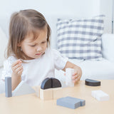 A child playing with the Plan Toys Fractions Blocks. 