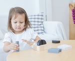 A child playing with the Plan Toys Fractions Blocks. 