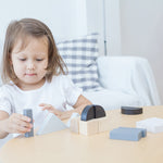 A child playing with the Plan Toys Fractions Blocks. 