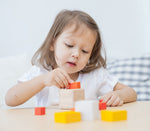 A child playing with the PlanToys Fractions Cubes. 