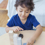 A child playing with the PlanToys 15 Cubes. 