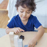 A child playing with the PlanToys 15 Cubes. 