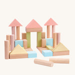 PlanToys 40 Pastel and Natural Blocks on a plain background. The blocks are shown out of the packaging built into a castle or palace like structure.