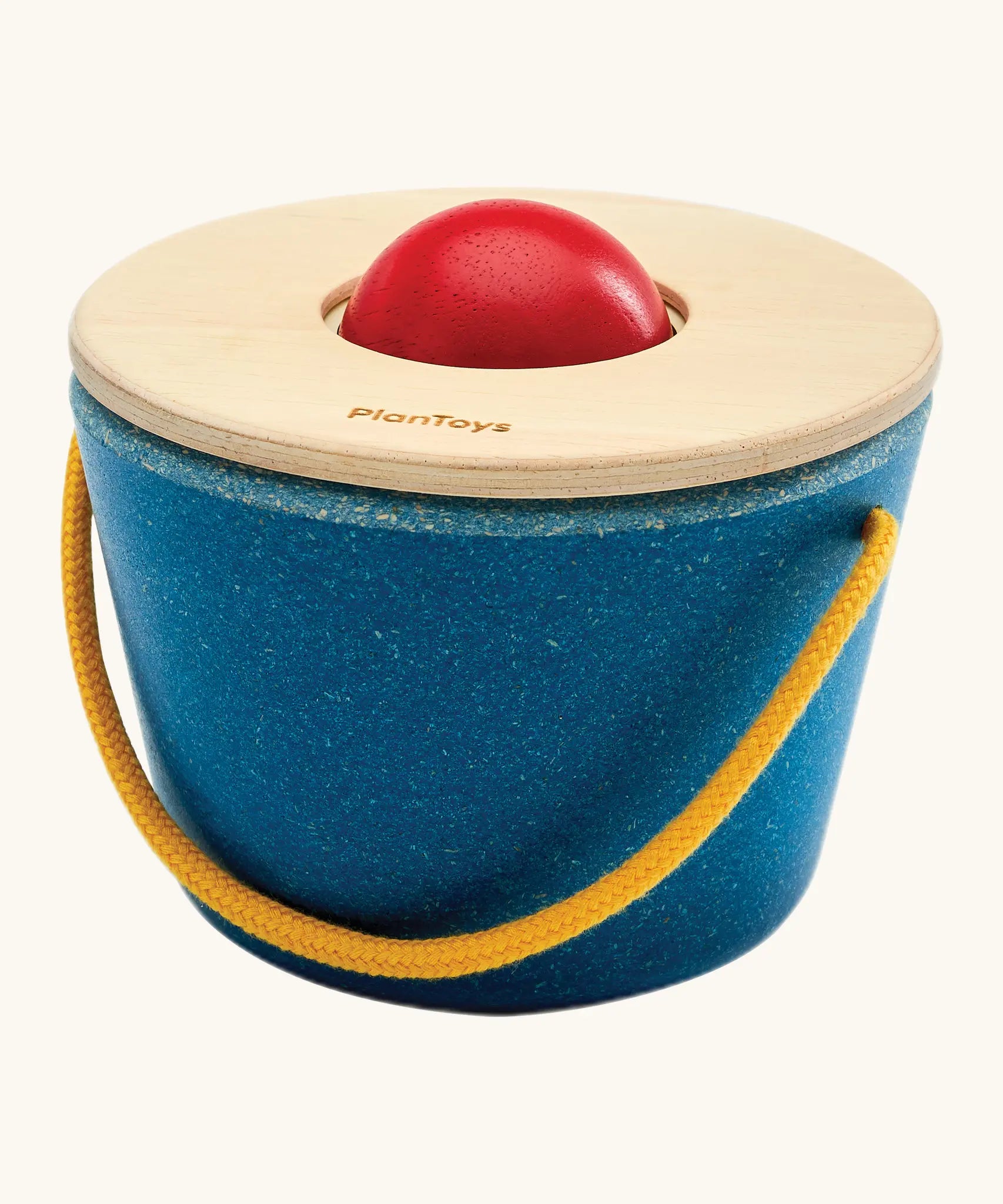 Educator sitting with a toddler learning object permanence with the ball drop toy