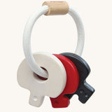 PlanToys wooden baby key rattle toy in a high contrast colourway. This baby toy has three wooden keys in white, red and black strung onto a white rope hoop. PlanToys range of toys are made from sustainably sourced rubberwood, we're proud stockists of PlanToys here at Babipur. 