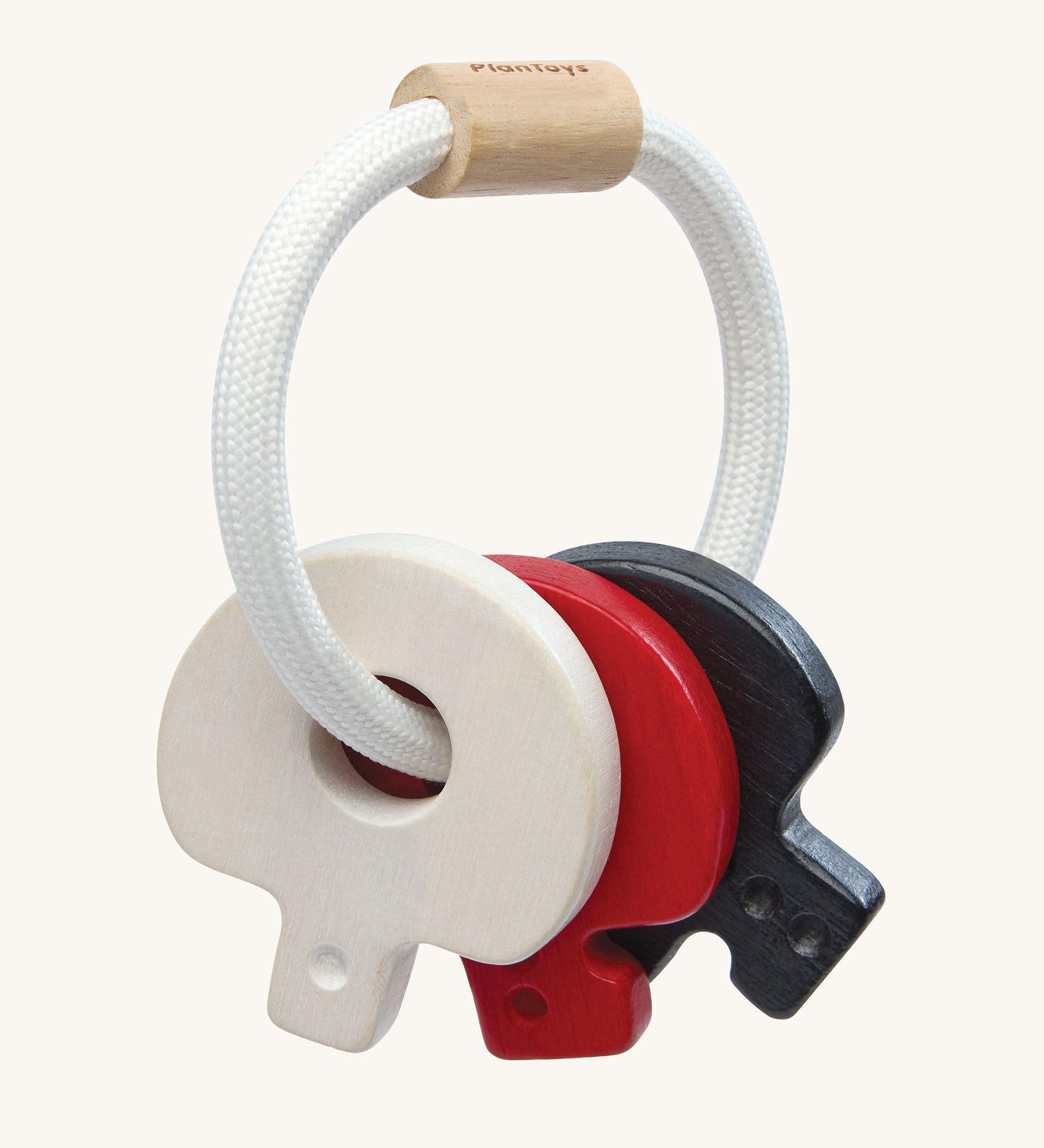 PlanToys wooden baby key rattle toy in a high contrast colourway. This baby toy has three wooden keys in white, red and black strung onto a white rope hoop. PlanToys range of toys are made from sustainably sourced rubberwood, we're proud stockists of PlanToys here at Babipur. 