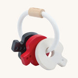PlanToys wooden baby key rattle toy in a high contrast colourway. This baby toy has three wooden keys in white, red and black strung onto a white rope hoop. PlanToys range of toys are made from sustainably sourced rubberwood, we're proud stockists of PlanToys here at Babipur. 