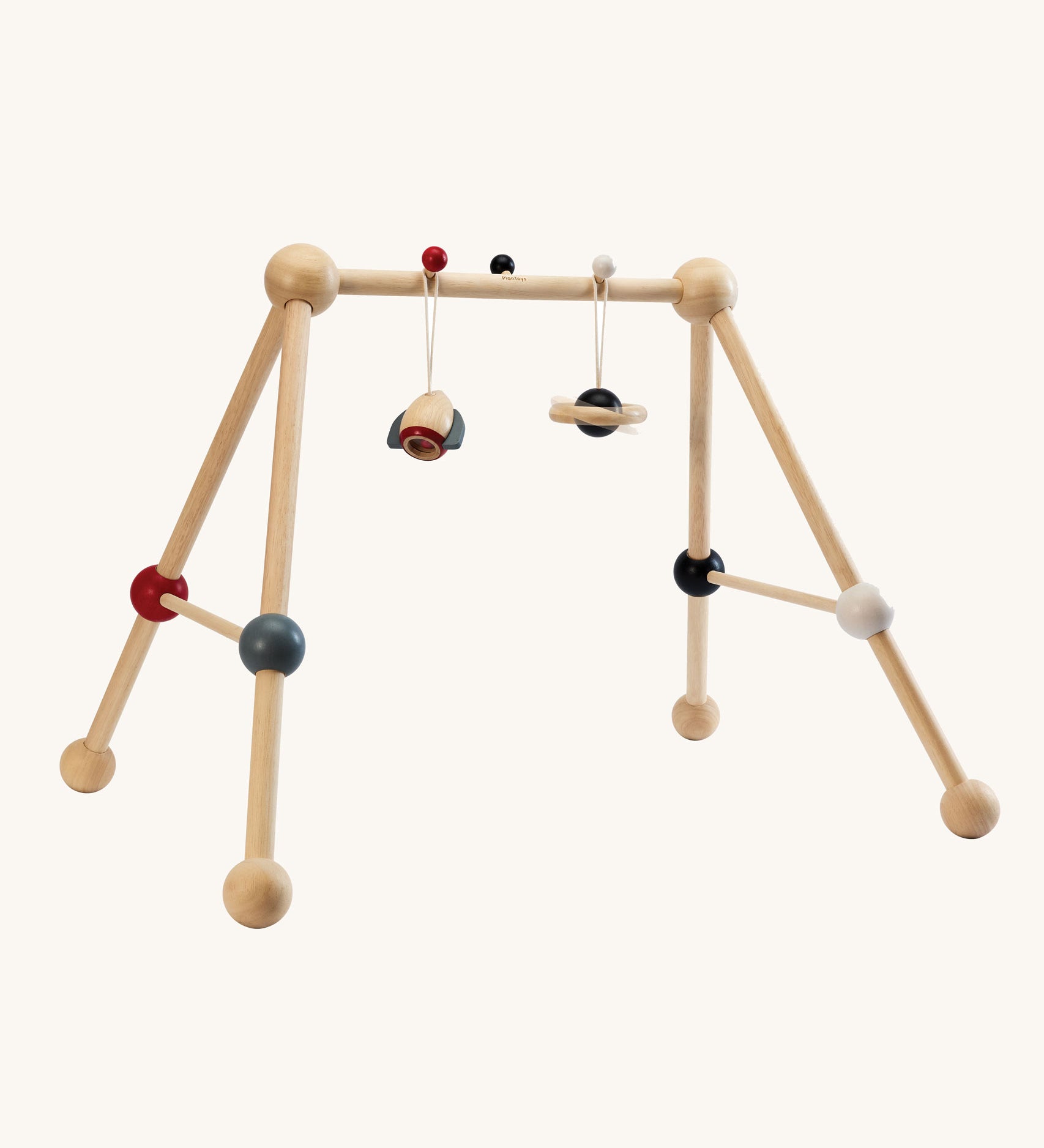PlanToys High Contrast Wooden Baby Play Gym. A wooden baby gym with high contrast coloured features and detailing. The gym comes with two wooden hanging toys, a planet and a rocket. PlanToys range of toys are made from sustainably sourced rubberwood, we're proud stockists of PlanToys here at Babipur. 