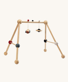 PlanToys High Contrast Wooden Baby Play Gym. A wooden baby gym with high contrast coloured features and detailing. The gym comes with two wooden hanging toys, a planet and a rocket. PlanToys range of toys are made from sustainably sourced rubberwood, we're proud stockists of PlanToys here at Babipur. 