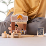 Child playing with the PlanToys bakery shop wooden toy playset.