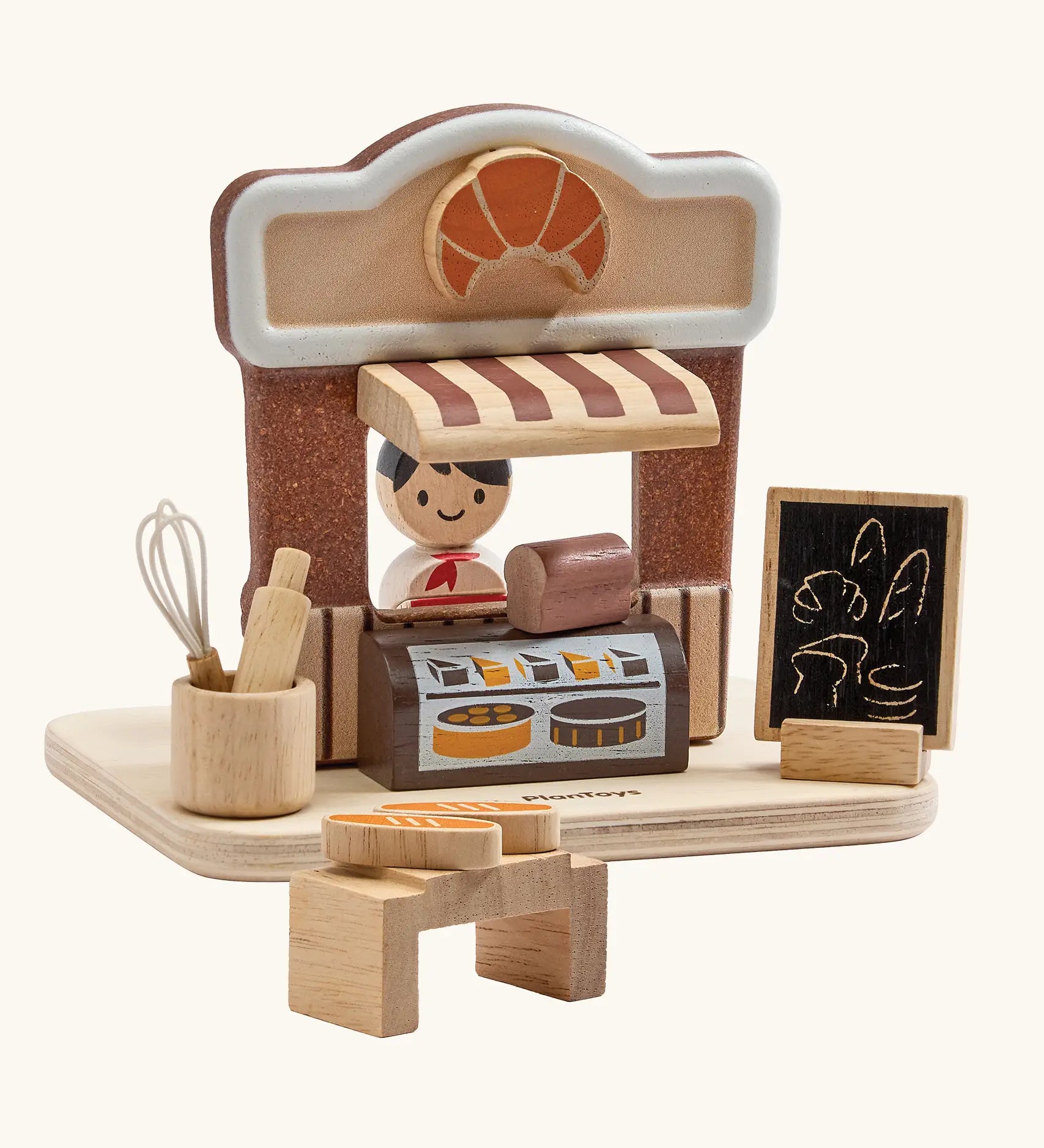 PlanToys bakery shop wooden toy playset. Shop with counter, toy bread, baking tools, advert board and worker figure.