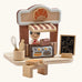 PlanToys bakery shop wooden toy playset. Shop with counter, toy bread, baking tools, advert board and worker figure.