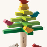 The PlanToys Balancing Tree on a plain background shown stacked up in a traditional tree style formation.
