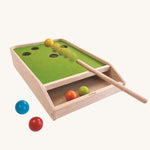 The PlanToys Ball Shoot Board Game on a plain background. Motion can be seen as the cue hits the yellow coloured ball. 