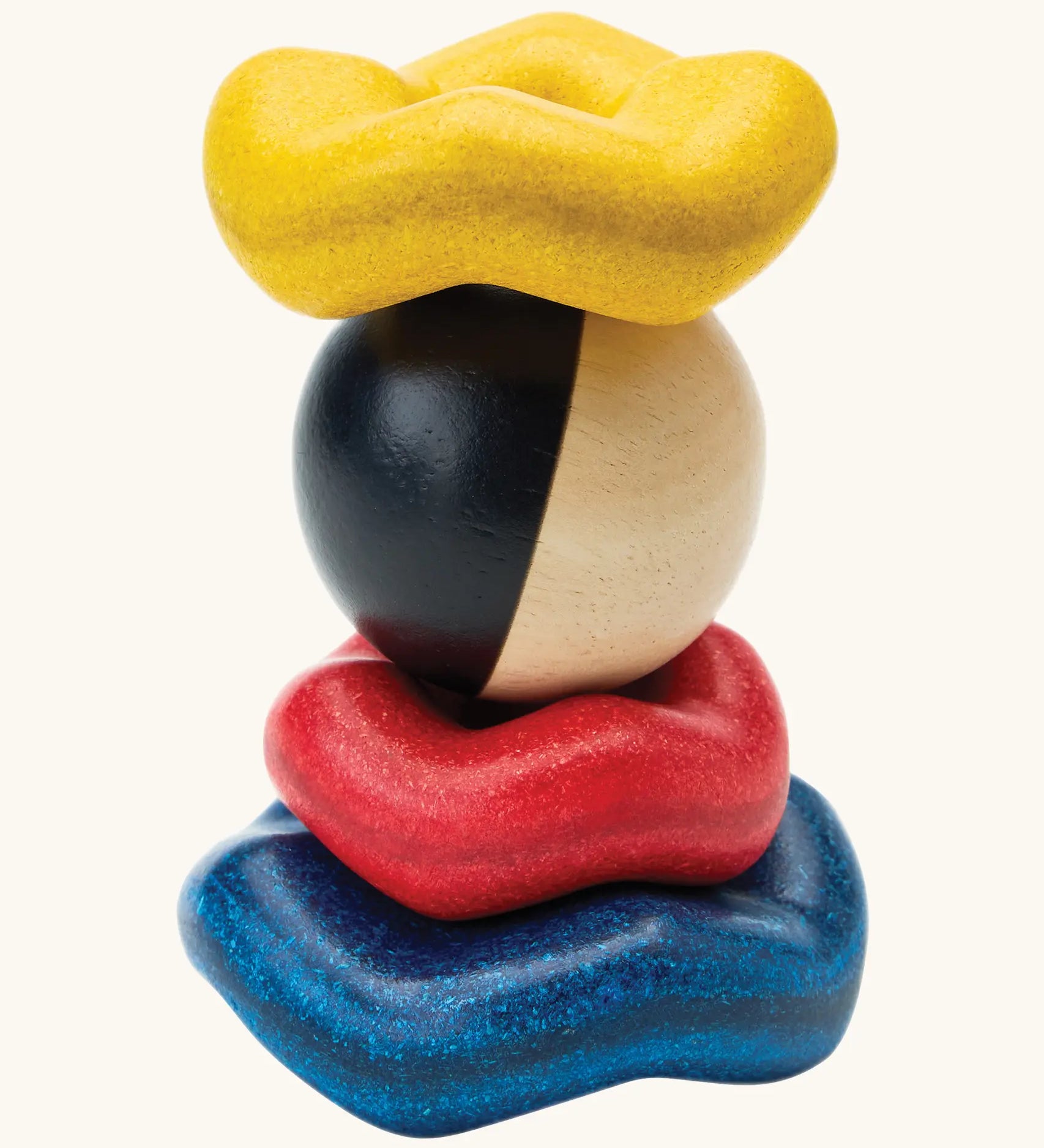 PlanToys wave ball stacker wooden stacking toy. Blue, yellow and red wavy rings with a black and white ball. 