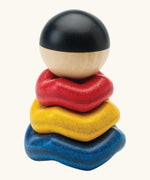 PlanToys wave ball stacker wooden stacking toy. Blue, yellow and red wavy rings with a black and white ball. 