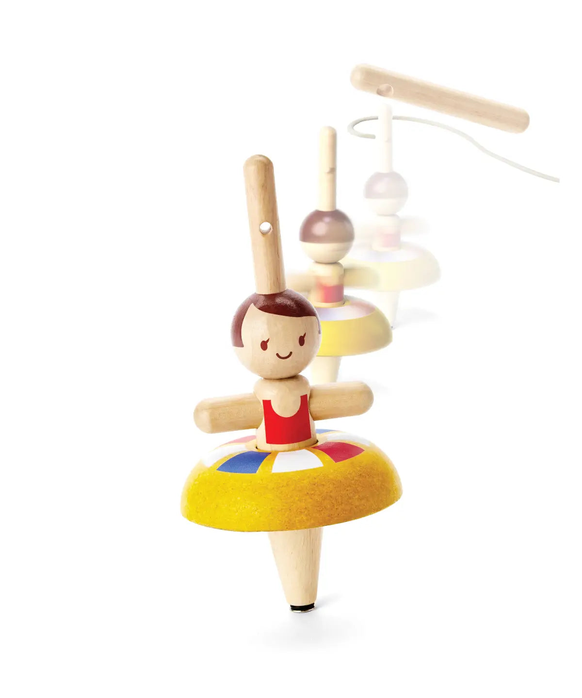 PlanToys wooden ballet spinning top. Showing the spinning top in action and the handle in the background.