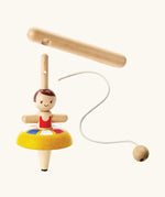 PlanToys wooden ballet spinning top. showing the handle, string to thread and a ballerina spinning top