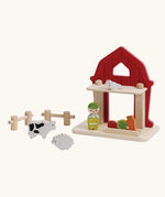PlanToys barn house small world play set. Red wooden barn, mini veg patch, fences, cow, sheep, hen and farmer figure. 