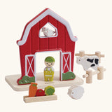 PlanToys barn house small world play set. Red wooden barn, mini veg patch, fences, cow, sheep, hen and farmer figure. 