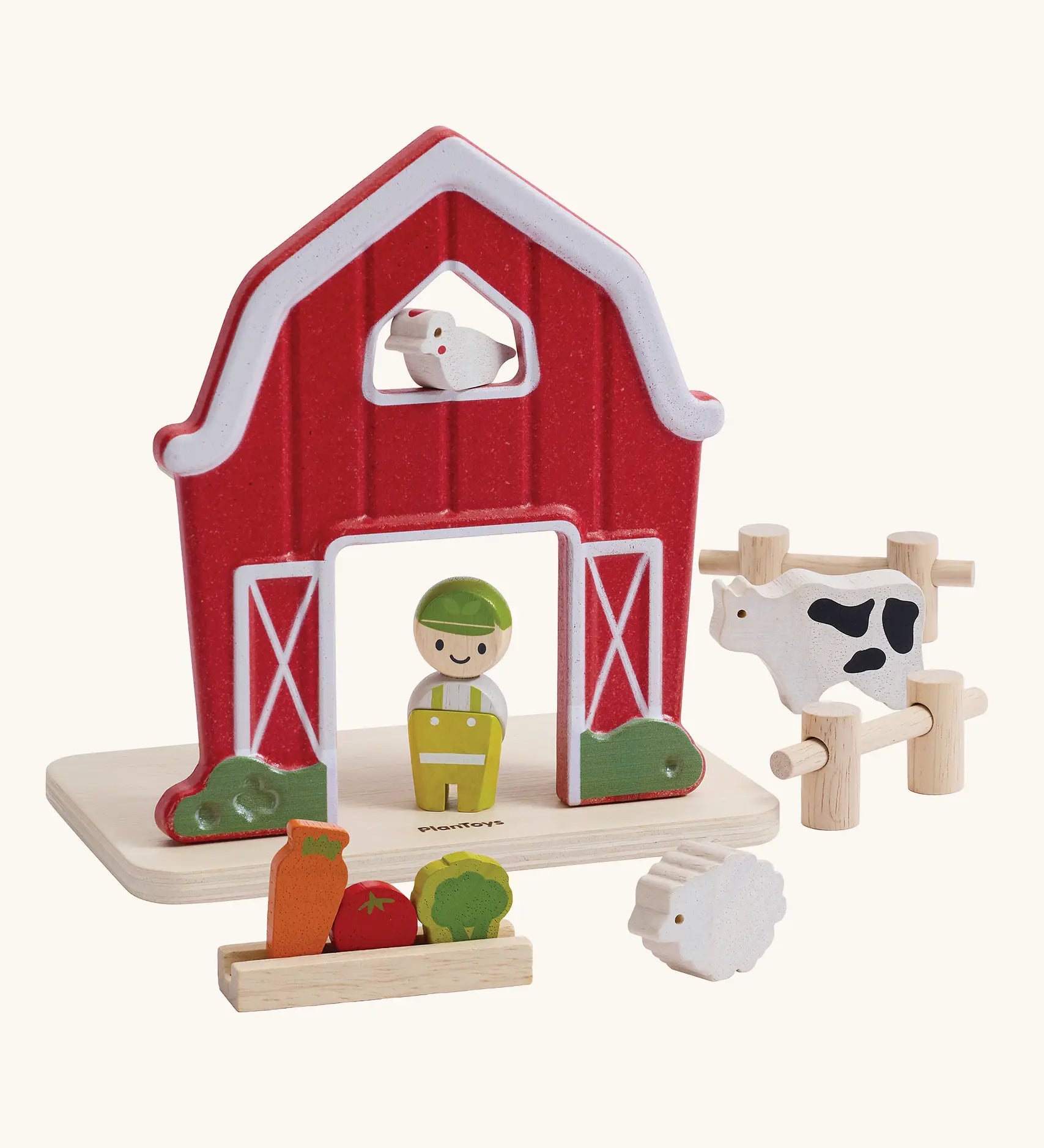 PlanToys barn house small world play set. Red wooden barn, mini veg patch, fences, cow, sheep, hen and farmer figure. 