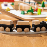 PlanToys black wooden classic toy train on a rubber railway track. 